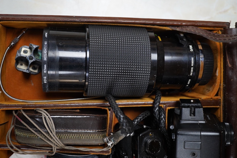 A cased Olympus camera, lenses and equipment, Condition - poor